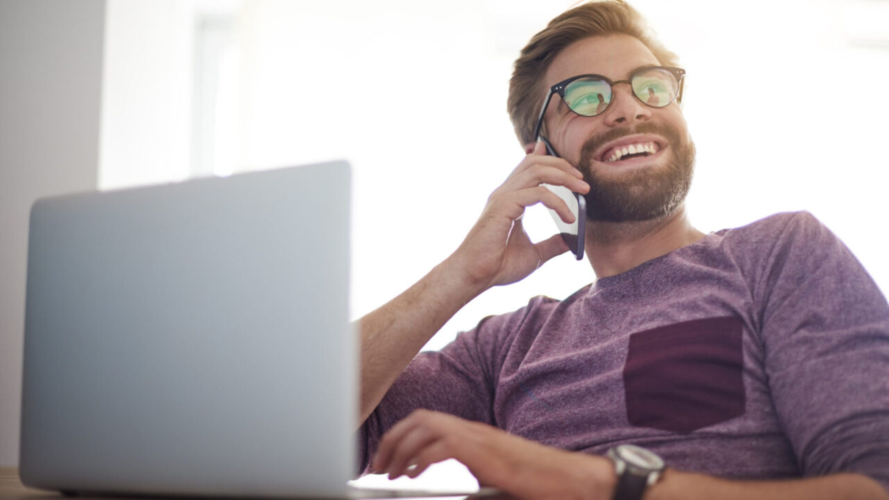 Happy man doing buisness in the home office